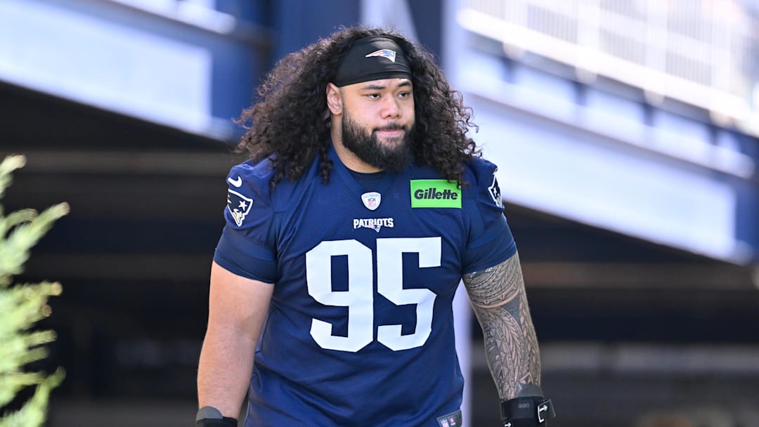 Jul 23, 2025; Foxborough, MA, USA; New England Patriots defensive tackle Khyiris Tonga (95)  walks to the practice field for training camp at Gillette Stadium. Mandatory Credit: Eric Canha-Imagn Images
