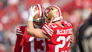 San Francisco 49ers running back Christian McCaffrey (23) embraces quarterback Brock Purdy (13).