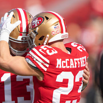 San Francisco 49ers running back Christian McCaffrey (23) embraces quarterback Brock Purdy (13).