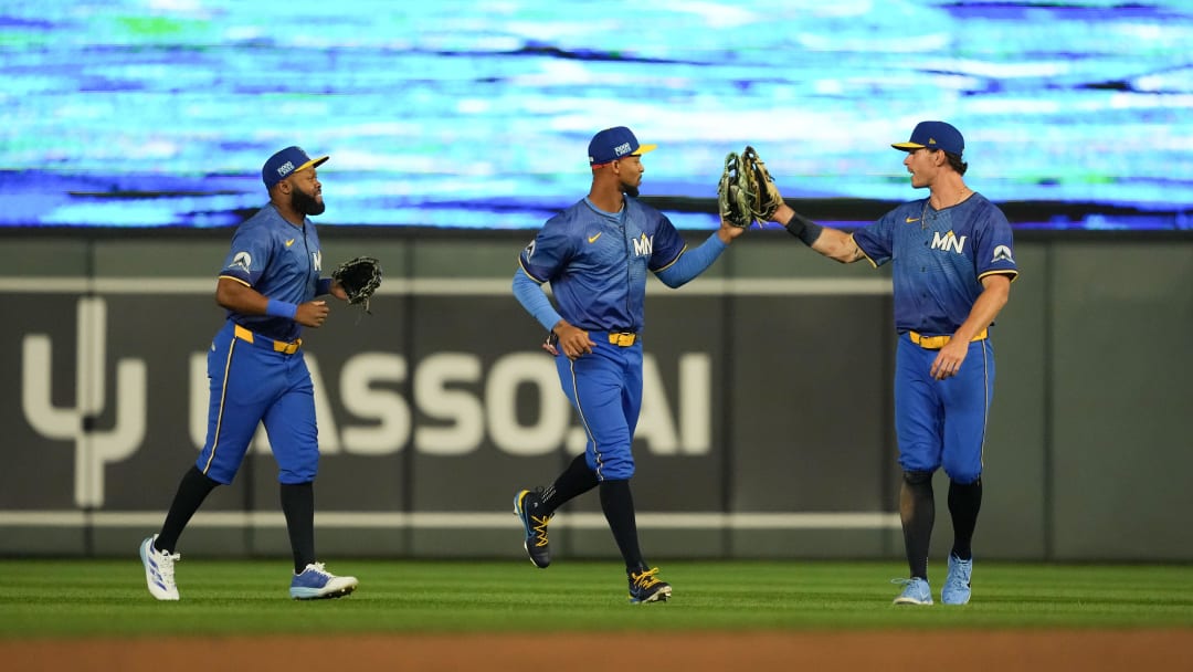 Aug 9, 2024; Minneapolis, Minnesota, USA; Minnesota Twins left fielder Matt Wallner (38) center fielder Bryon Buxton (25) and right fielder Max Kepler (26) celebrate after defeating the Cleveland Guardians at Target Field. Mandatory Credit: Jordan Johnson-USA TODAY Sports