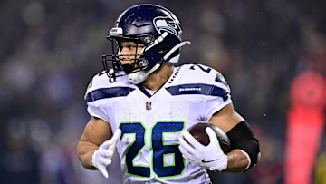 Dec 26, 2024; Chicago, Illinois, USA; Seattle Seahawks running back Zach Charbonnet (26) runs the ball against the Chicago Bears during the first quarter at Soldier Field. Mandatory Credit: Daniel Bartel-Imagn Images