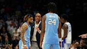 Mar 14, 2025; Charlotte, NC, USA; North Carolina Tar Heels head coach Hubert Davis talks with guard RJ Davis (4) as forward Jae'Lyn Withers (24) looks on in the second half at Spectrum Center. 