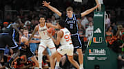 Feb 25, 2025; Coral Gables, Florida, USA;  Duke Blue Devils guard Cooper Flagg (2) defends Miami (Fl) Hurricanes guard Divine Ugochukwu (99) during the first half at Watsco Center. Mandatory Credit: Jim Rassol-Imagn Images