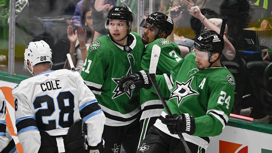 Apr 12, 2025; Dallas, Texas, USA; Dallas Stars left wing Jason Robertson (21) and defenseman Matt Dumba (3) and center Roope Hintz (24) celebrates a goal scored by Robertson against the Utah Hockey Club during the second period at the American Airlines Center. Mandatory Credit: Jerome Miron-Imagn Images