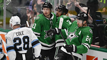 Apr 12, 2025; Dallas, Texas, USA; Dallas Stars left wing Jason Robertson (21) and defenseman Matt Dumba (3) and center Roope Hintz (24) celebrates a goal scored by Robertson against the Utah Hockey Club during the second period at the American Airlines Center. Mandatory Credit: Jerome Miron-Imagn Images