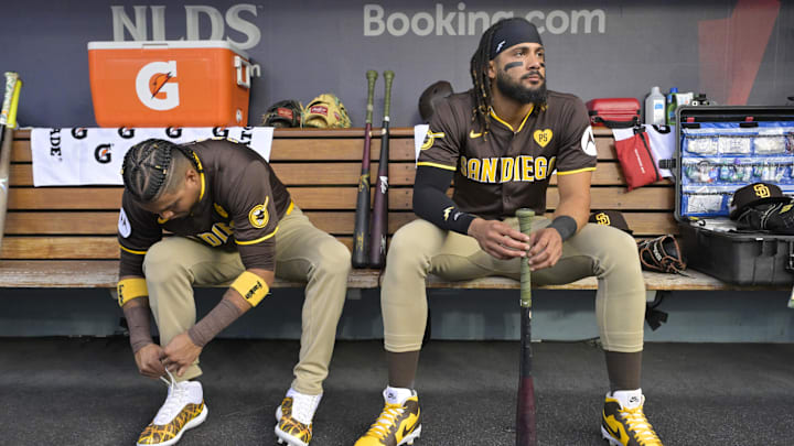 Oct 11, 2024; Los Angeles, California, USA; San Diego Padres first baseman Luis Arraez (4) and outfielder Fernando Tatis Jr. (23) look on in the dugout before game five against the Los Angeles Dodgers in the NLDS for the 2024 MLB Playoffs at Dodger Stadium. Mandatory Credit: Jayne Kamin-Oncea-Imagn Images Oct 11, 2024; Los Angeles, California, USA; San Diego Padres first baseman Luis Arraez (4) and outfielder Fernando Tatis Jr. (23) look on in the dugout before game five against the Los Angeles Dodgers in the NLDS for the 2024 MLB Playoffs at Dodger Stadium. Mandatory Credit: Jayne Kamin-Oncea-Imagn Images