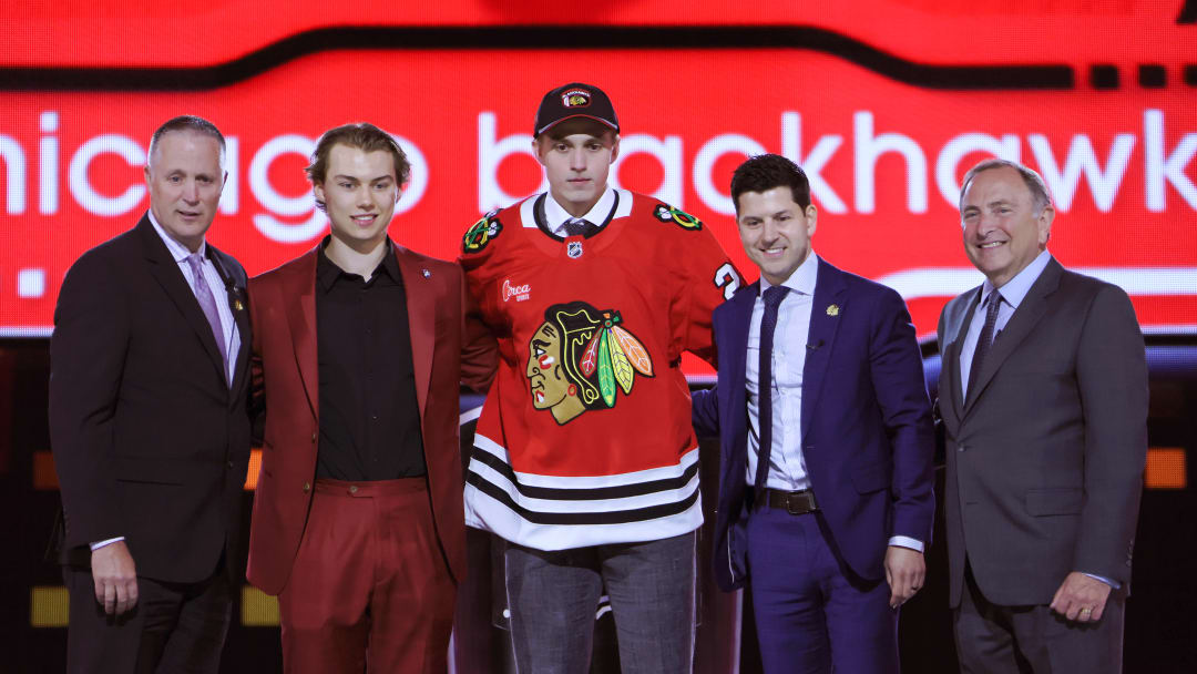 Chicago Blackhawks front office and star forward Connor Bedard announce Chicago's second overall pick, Artyom Levshunov (middle)