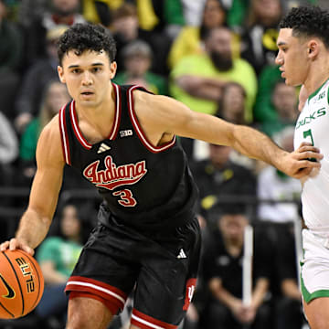 Indiana's Anthony Leal (3) drives against Oregon's Jackson Shelstad (3) at Matthew Knight Arena. 