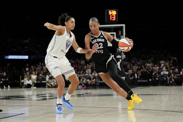 Las Vegas Aces center A'ja Wilson dribbles the ball against Golden State Valkyries forward Janelle Salaun. 