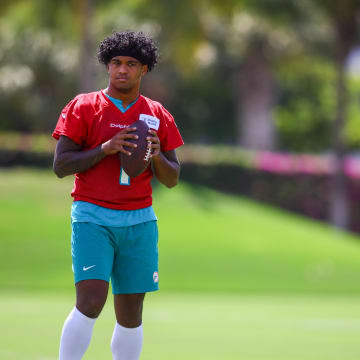 Jun 5, 2024; Miami Gardens, FL, USA; Miami Dolphins quarterback Tua Tagovailoa (1) looks on during mandatory minicamp at Baptist Health Training Complex.