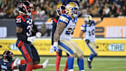 Nov 19, 2023; Hamilton, Ontario, CAN;  Winnipeg Blue Bombers running back Brady Oliveira (20) celebrates after scoring a touchdown past Montreal Alouettes defensive back Reggie Stubblefield (35) in the first half at Tim Hortons Field. Mandatory Credit: Dan Hamilton-Imagn Images