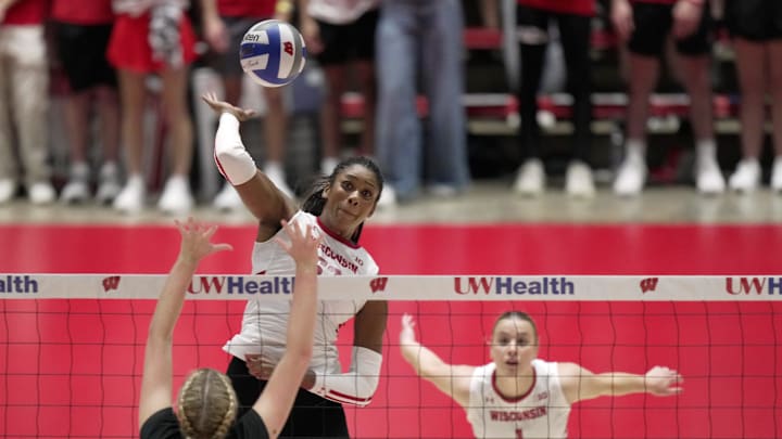 Wisconsin middle blocker Carter Booth hits the ball past UW-Milwaukee middle blocker Josie Noble during their volleyball match Tuesday, September 9, 2025 at the Wisconsin Field House in Madison, Wisconsin. Wisconsin beat UW-Milwaukee 3-0.