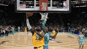 Jan 27, 2025; Charlotte, North Carolina, USA; Los Angeles Lakers forward LeBron James (23) goes up for a layup past Charlotte Hornets center Mark Williams (5) during the second half at the Spectrum Center. Mandatory Credit: Jim Dedmon-Imagn Images