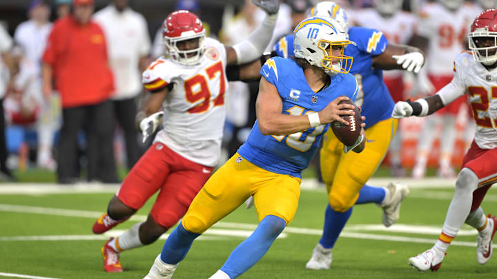 Los Angeles Chargers quarterback Justin Herbert is pressured by Kansas City Chiefs defensive end Felix Anudike-Uzomah.