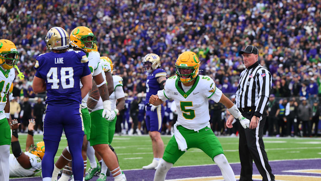 Nov 29, 2025; Seattle, Washington, USA; Oregon Ducks quarterback Dante Moore (5) celebrates after scoring a touchdown against the Washington Huskies during the first half at Husky Stadium. Mandatory Credit: Steven Bisig-Imagn Images