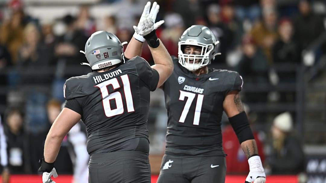 Nov 15, 2025; Pullman, Washington, USA; Washington State Cougars offensive lineman Christian Hilborn (61) and Washington State Cougars offensive lineman Ashton Tripp (71) celebrate after a touchdown against the Louisiana Tech Bulldogs in the first half at Gesa Field at Martin Stadium. Mandatory Credit: James Snook-Imagn Images