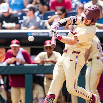 Jun 18, 2024; Omaha, NE, USA; Florida State Seminoles right fielder James Tibbs III (22) hits a double against the North Carolina Tar Heels during the fifth inning at Charles Schwab Field Omaha. 