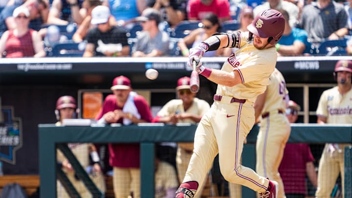 Jun 18, 2024; Omaha, NE, USA; Florida State Seminoles right fielder James Tibbs III (22) hits a double against the North Carolina Tar Heels during the fifth inning at Charles Schwab Field Omaha. 