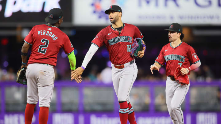 Aug 20, 2024; Miami, Florida, USA; Arizona Diamondbacks left fielder Lourdes Gurriel Jr. (12) celebrates with shortstop Geraldo Perdomo (2) and right fielder Corbin Carroll (7) after the game against the Miami Marlins at loanDepot Park. Mandatory Credit: Sam Navarro-USA TODAY Sports