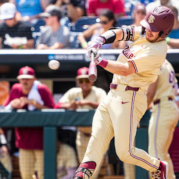 Jun 18, 2024; Omaha, NE, USA; Florida State Seminoles right fielder James Tibbs III (22) hits a double against the North Carolina Tar Heels during the fifth inning at Charles Schwab Field Omaha. 