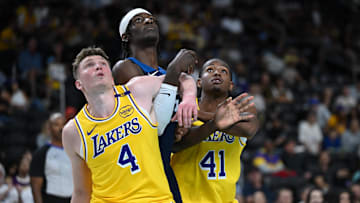 Oct 4, 2024; Palm Desert, California, USA; Los Angeles Lakers guard Dalton Knecht (4) and guard Quincy Olivari (41) watch a free throw against Minnesota Timberwolves forward Leonard Miller (33) during the second half at Acrisure Arena. Mandatory Credit: Jonathan Hui-Imagn Images