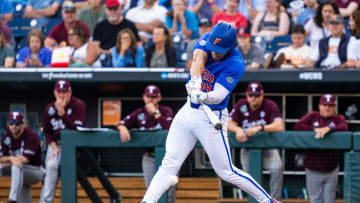 Jun 19, 2024; Omaha, NE, USA; Florida Gators first baseman Jac Caglianone (14) hits a single against the Texas A&M Aggies during the third inning at Charles Schwab Field Omaha. Mandatory Credit: Dylan Widger-USA TODAY Sports