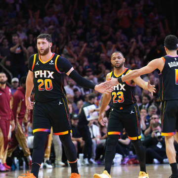Apr 3, 2024; Phoenix, Arizona, USA; Phoenix Suns guard Devin Booker (1) slaps hands with Phoenix Suns center Jusuf Nurkic (20) and Phoenix Suns guard Eric Gordon (23) and Phoenix Suns forward Royce O'Neale (00) during the first half of the game against the Cleveland Cavaliers at Footprint Center. Mandatory Credit: Joe Camporeale-USA TODAY Sports