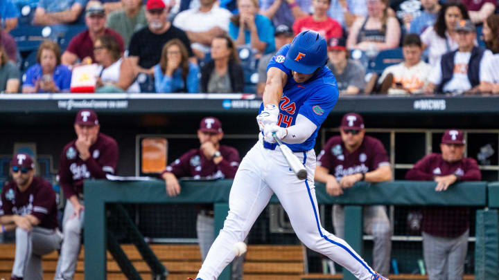 Jun 19, 2024; Omaha, NE, USA; Florida Gators first baseman Jac Caglianone (14) hits a single against the Texas A&M Aggies during the third inning at Charles Schwab Field Omaha. Mandatory Credit: Dylan Widger-USA TODAY Sports