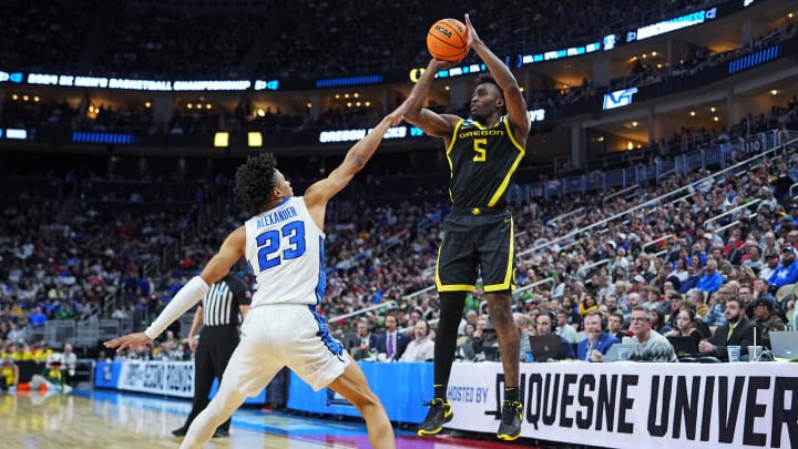Mar 23, 2024; Pittsburgh, PA, USA; Oregon Ducks guard Jermaine Couisnard (5) shoots the ball against Creighton Bluejays guard Trey Alexander (23) during the first half in the second round of the 2024 NCAA Tournament at PPG Paints Arena.