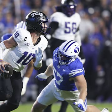 Nov 15, 2025; Provo, Utah, USA; Texas Christian University Horned Frogs quarterback Josh Hoover (10) is pressured by BYU Cougars defensive tackle Keanu Tanuvasa (57) during the second quarter at LaVell Edwards Stadium. Mandatory Credit: Rob Gray-Imagn Images