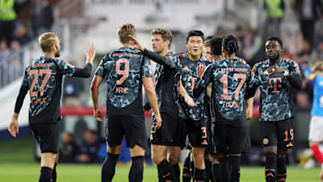Bayern Munich players celebrating a goal against Holstein Kiel on matchday three of the Bundesliga.