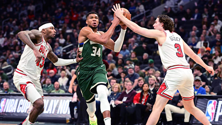 Nov 20, 2024; Milwaukee, Wisconsin, USA; Milwaukee Bucks forward Giannis Antetokounmpo (34) drives between Chicago Bulls forward Torrey Craig (13) and guard Josh Giddey (3) in the fourth quarter at Fiserv Forum. Mandatory Credit: Benny Sieu-Imagn Images