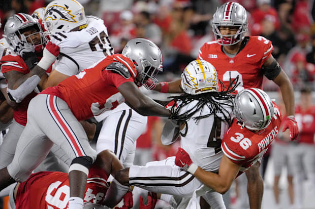 Western Michigan Broncos running back Keshawn King (4) is tackled by Ohio State Buckeyes defensive end Joshua Mickens (52), O