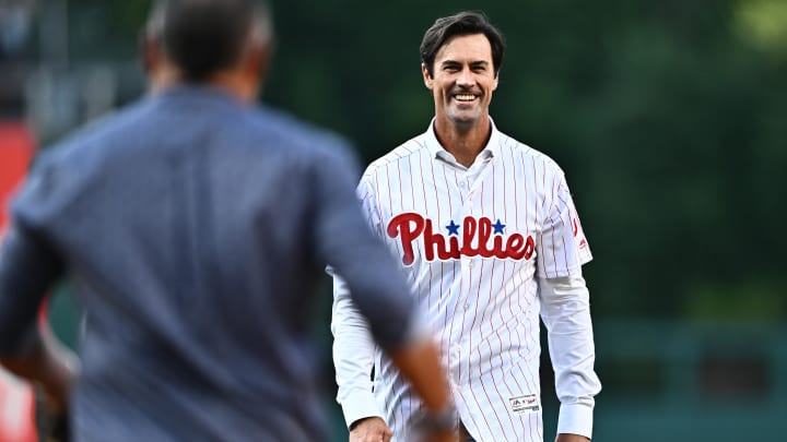 Jun 21, 2024; Philadelphia, Pennsylvania, USA; Former Philadelphia Phillies pitcher Cole Hamels reacts after throwing a ceremonial first pitch with former catcher Carlos Ruiz before the game against the Arizona Diamondbacks at Citizens Bank Park. Mandatory Credit: Kyle Ross-USA TODAY Sports