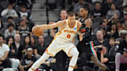 Nov 20, 2025; San Antonio, Texas, USA; Atlanta Hawks player Kristaps Porzingis (8) posts up against San Antonio Spurs guard Devin Vassell (24) during the first half against the San Antonio Spurs at Frost Bank Center. Mandatory Credit: Scott Wachter-Imagn Images