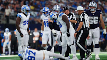 Oct 13, 2024; Arlington, Texas, USA;  Detroit Lions defensive end Aidan Hutchinson (97) injures himself while trying to tackle Dallas Cowboys quarterback Dak Prescott (not pictured) during the second half at AT&T Stadium. Mandatory Credit: Kevin Jairaj-Imagn Images
