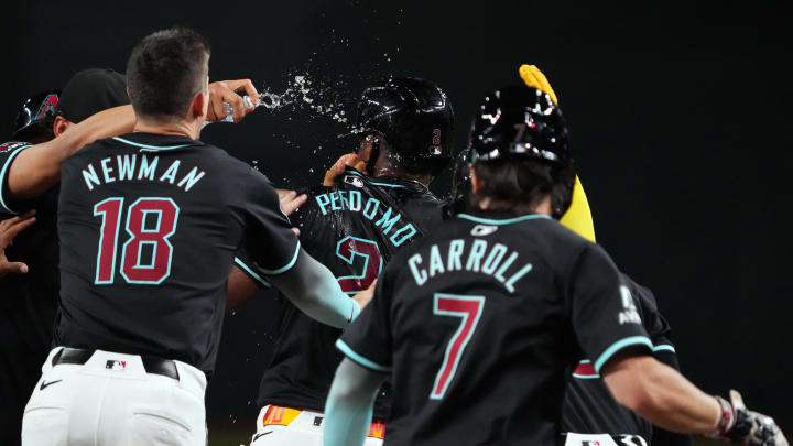 Jul 12, 2024; Phoenix, Arizona, USA; Arizona Diamondbacks shortstop Geraldo Perdomo (2) celebrates with teammates after hitting a walk off sacrifice fly RBI against the Toronto Blue Jays during the ninth inning at Chase Field. Mandatory Credit: Joe Camporeale-USA TODAY Sports