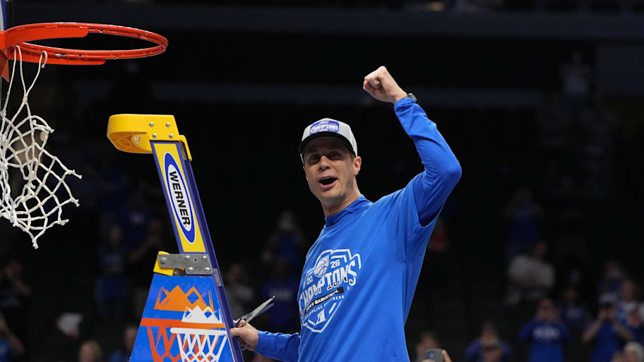 Duke Blue Devils head coach Jon Scheyer cuts down the net after defeating the Virginia Cavaliers in the ACC championship.