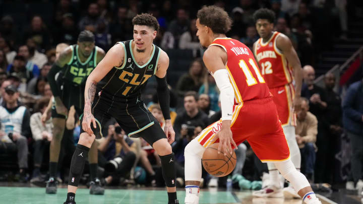 Dec 16, 2022; Charlotte, North Carolina, USA; Charlotte Hornets guard LaMelo Ball (1) back on defense against Atlanta Hawks guard Trae Young (11) during the second half at Spectrum Center. Mandatory Credit: Jim Dedmon-USA TODAY Sports