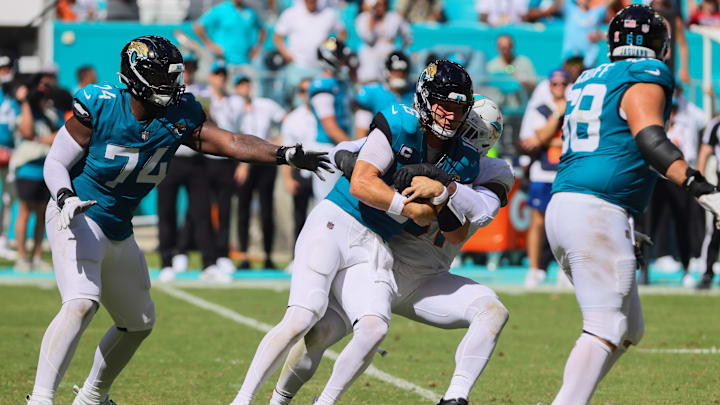 Sep 8, 2024; Miami Gardens, Florida, USA; Jacksonville Jaguars quarterback Trevor Lawrence (16) is sacked by Miami Dolphins defensive tackle Da'Shawn Hand (91) during the fourth quarter at Hard Rock Stadium. Mandatory Credit: Sam Navarro-Imagn Images