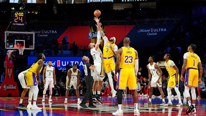 Dec 7, 2023; Las Vegas, Nevada, USA; New Orleans Pelicans center Jonas Valanciunas (17) and Los Angeles Lakers forward Anthony Davis (3) go for the opening tip of the NBA In Season Tournament Semifinal at T-Mobile Arena. 