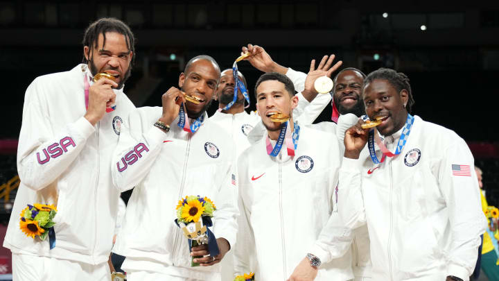 Aug 7, 2021; Saitama, Japan; United States guard Devin Booker (center) and teammates celebrate after winning the gold medal during the Tokyo 2020 Olympic Summer Games at Saitama Super Arena. Mandatory Credit: Kyle Terada-USA TODAY Sports