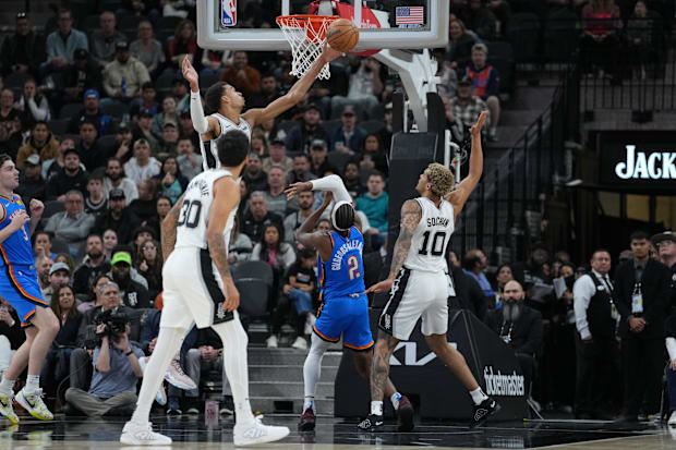 San Antonio Spurs center Victor Wembanyama (1) blocks a shot from Oklahoma City Thunder guard Shai Gilgeous-Alexander (2).