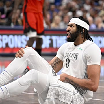 Dallas Mavericks forward Anthony Davis (3) grabs his midsection with an apparent injury.
