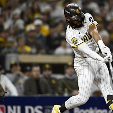 Oct 9, 2024; San Diego, California, USA; San Diego Padres outfielder Fernando Tatis Jr. (23) doubles in the third inning against the Los Angeles Dodgers during game four of the NLDS for the 2024 MLB Playoffs at Petco Park.  Mandatory Credit: Denis Poroy-Imagn Images