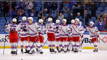 Dec 11, 2024; Buffalo, New York, USA;  The New York Rangers celebrate a win over the Buffalo Sabres at KeyBank Center. Mandatory Credit: Timothy T. Ludwig-Imagn Images