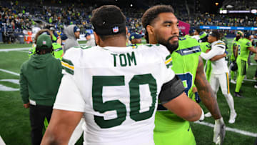 Dec 15, 2024; Seattle, Washington, USA; Green Bay Packers guard Zach Tom (50) and Seattle Seahawks defensive end Leonard Williams (99) after the game at Lumen Field. Mandatory Credit: Steven Bisig-Imagn Images