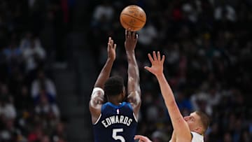 Mar 12, 2025; Denver, Colorado, USA; Minnesota Timberwolves guard Anthony Edwards (5) shoots over Denver Nuggets center Nikola Jokic (15) in the second half at Ball Arena. Mandatory Credit: Ron Chenoy-Imagn Images