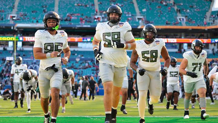 Jan 1, 2026; Miami Gardens, FL, USA; Oregon Ducks tight end Kade Caton (85), offensive lineman Fox Crader (59) and offensive lineman Ziyare Addison (58) warm up prior to the 2025 Orange Bowl and quarterfinal game of the College Football Playoff against the Texas Tech Red Raiders at Hard Rock Stadium. Mandatory Credit: Sam Navarro-Imagn Images