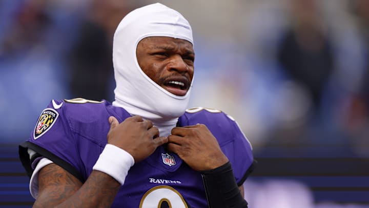 Baltimore Ravens quarterback Lamar Jackson (8) looks on.